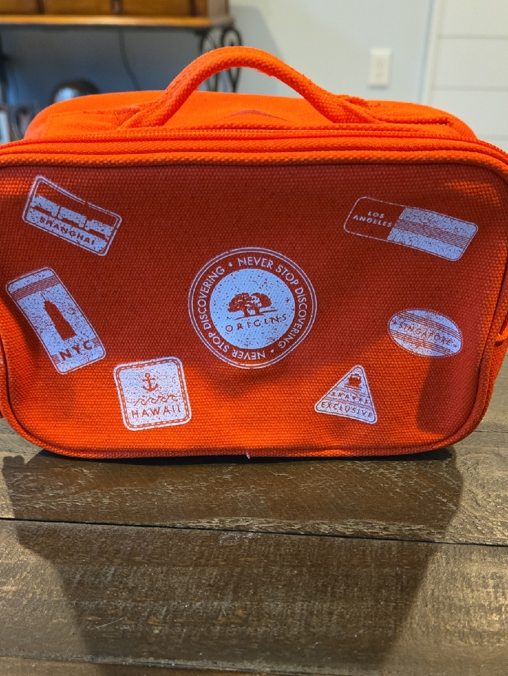 Origins Bright Orange Canvas Travel Pouch with White Patch Graphics